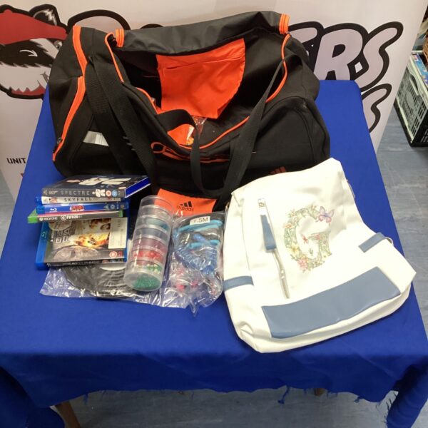 Adidas F50 sports bag with mixed contents, a pre-owned sports holder.