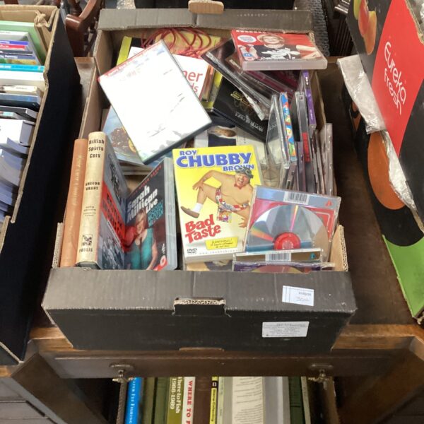 Mixed lot of CDs and DVDs including comedy and music.