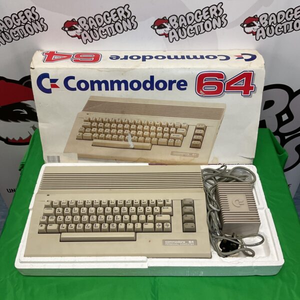 Vintage Commodore 64 computer with power supply for retro gaming.