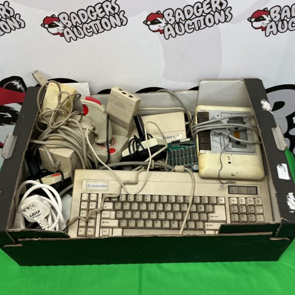 Vintage Commodore computer accessories including keyboard and cassette deck.