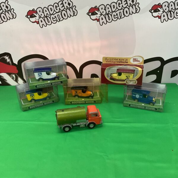 Diecast model collection lot including football souvenirs and vintage vehicles.