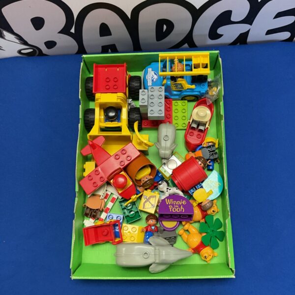 Mixed lot of Lego Duplo blocks with Winnie the Pooh and Jurassic World elements.
