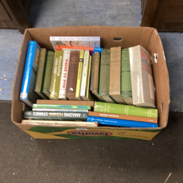 Stack of vintage fishing books in a cardboard box.