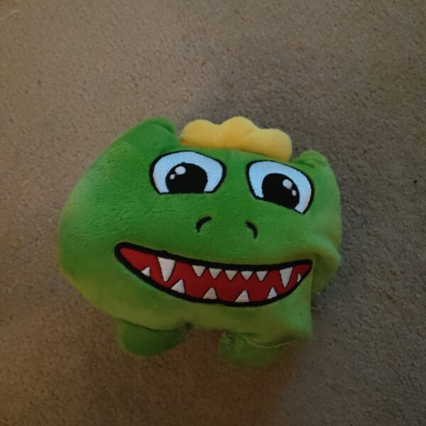 Cute green goblin plush toy with a mischievous expression.