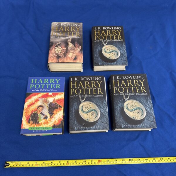 Five first edition Harry Potter books by J.K. Rowling, a collectible set.