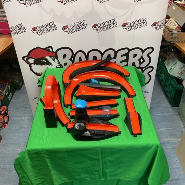 Hot Wheels Booster B1 track segment on a green surface.