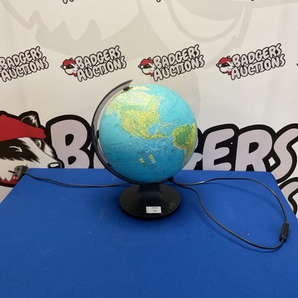 Illuminated world globe on a black base, detailed geographic markings.