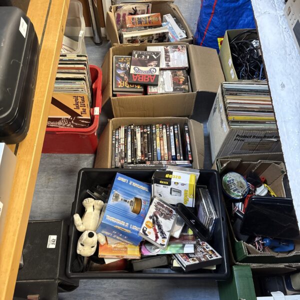 Mixed lot of DVD and CD boxes for entertainment.
