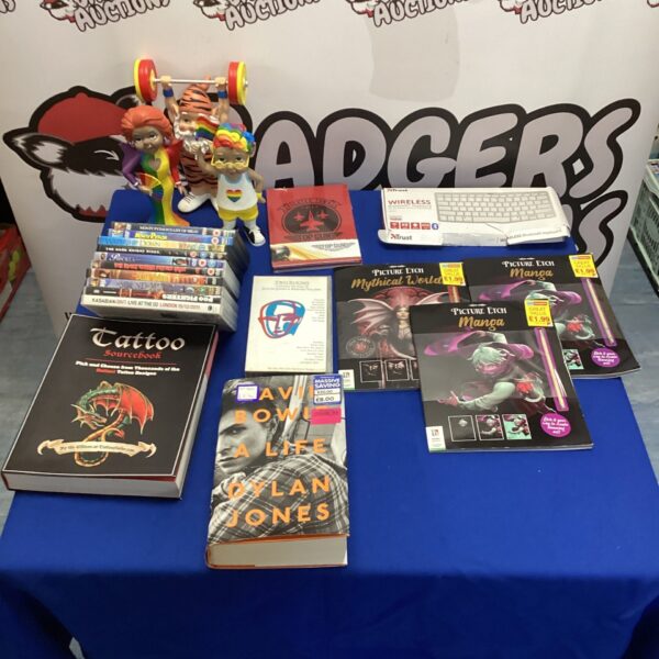 Mixed lot of DVDs, books, and a garden gnome for collectors.