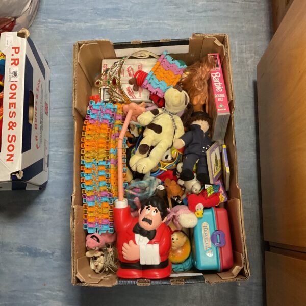 Mixed toy lot including a Barbie VHS tape and vintage toys.