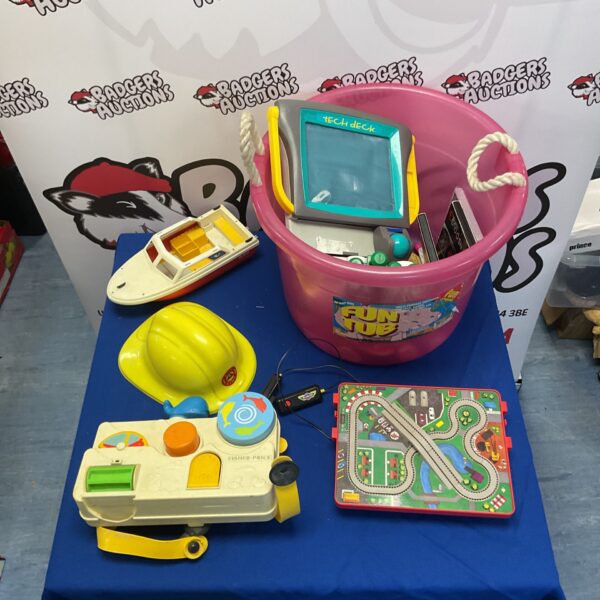 Mixed toy lot with Fisher Price and tech deck in a bucket.