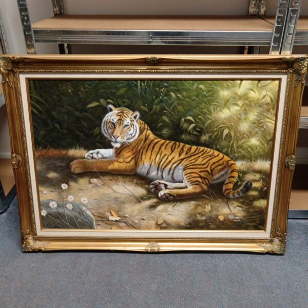 Front view of a large oil painting of a tiger in a gilt frame.
