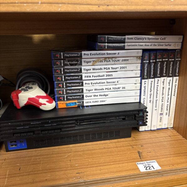Sony PlayStation 2 console with a collection of games.