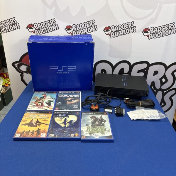 Boxed Sony PlayStation 2 console with games, retro gaming system.