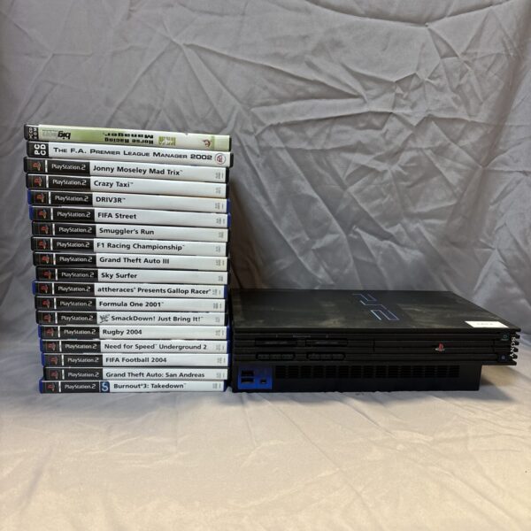 PlayStation 2 console with a large collection of games.