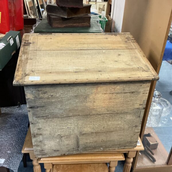 Front view of a rustic wooden coal box on a table.