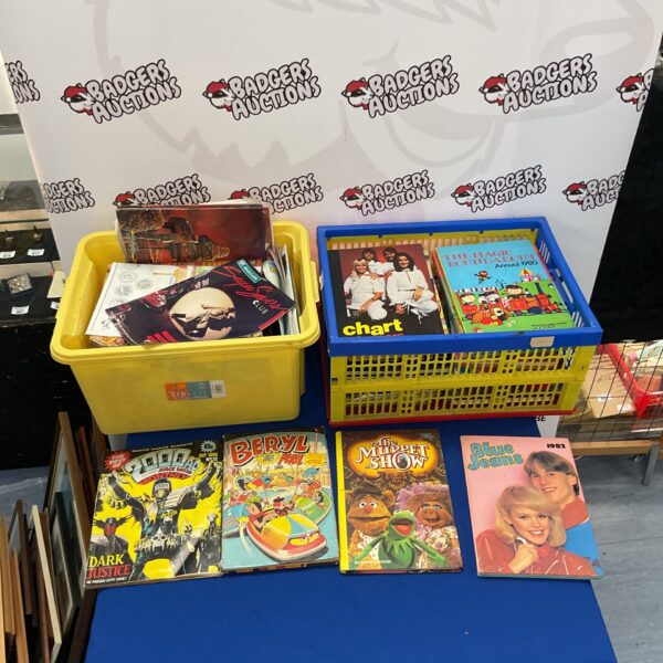 Two crates filled with vintage annuals and comics for collectors.