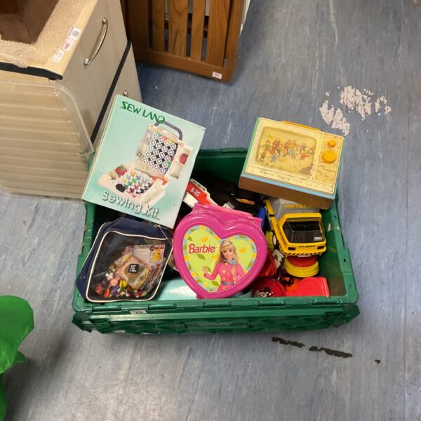 Vintage children's toy lot including Fisher Price TV and Barbie box.
