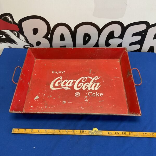 Vintage Coca-Cola metal tray, collectible advertising memorabilia.