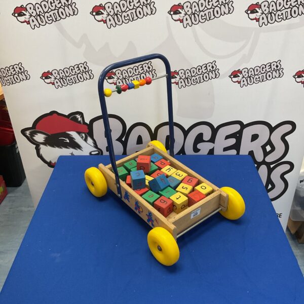 Vintage wooden letter trolley with colourful blocks.