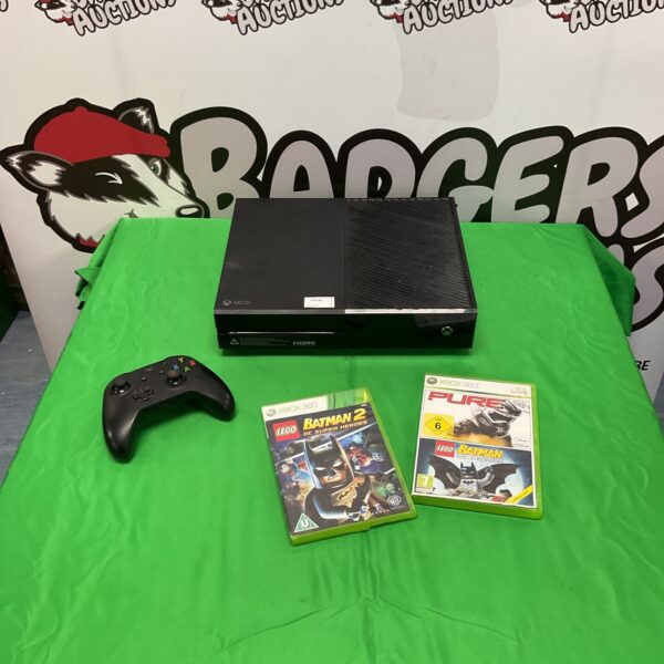 Xbox One console with remote and Lego Batman game visible.