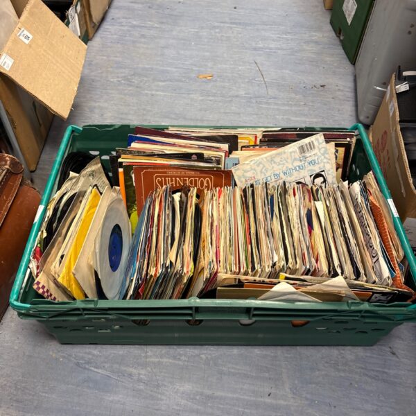 Crate full of vintage 7 inch vinyl singles for collectors.