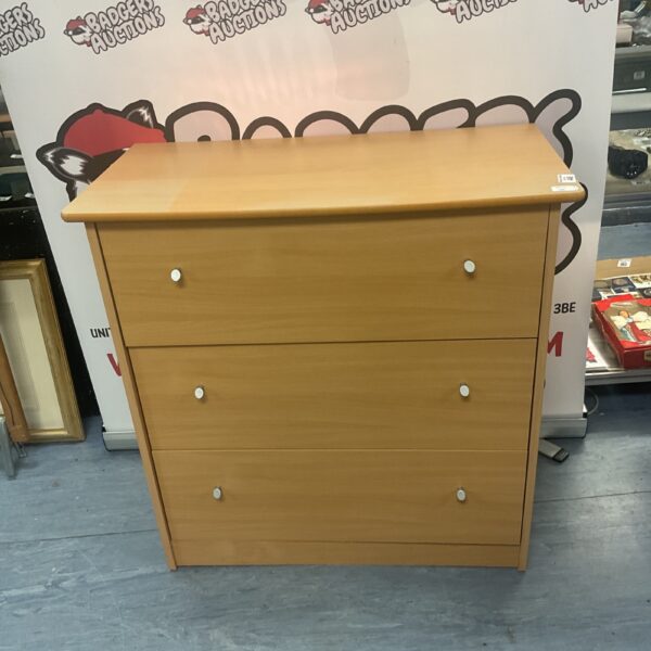Beech effect chest of three drawers for bedroom storage.