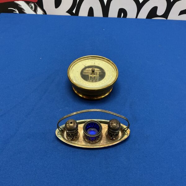 Antique brass Casella barometer with silverplate cruet set.