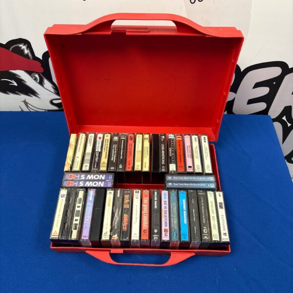Red carrying case filled with vintage cassette tapes.