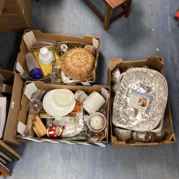 Mixed catering and dining lot with plates, glasses, and foil trays.