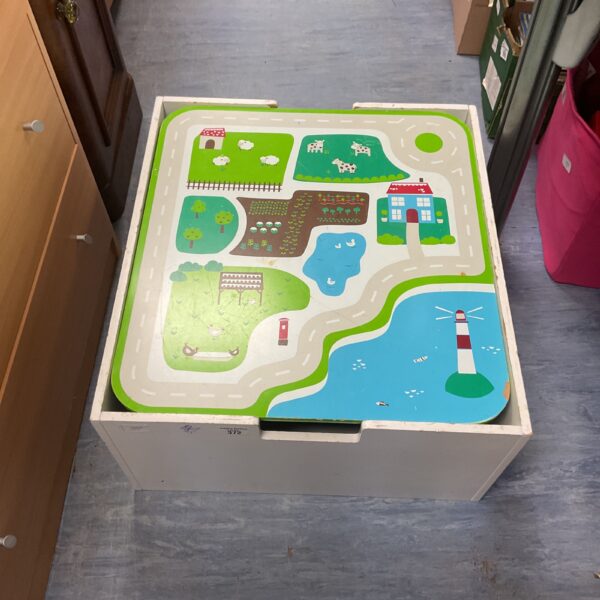 Colourful childrens toy storage box with integrated play mat.