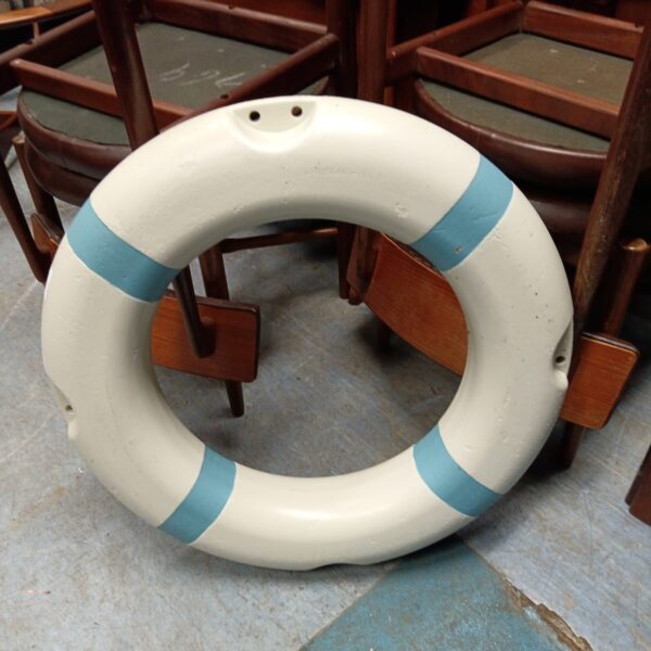 White and blue decorative life ring for nautical wall decor.