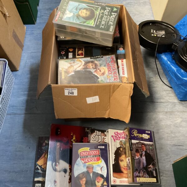 Mixed lot of DVDs and VHS tapes for film enthusiasts.