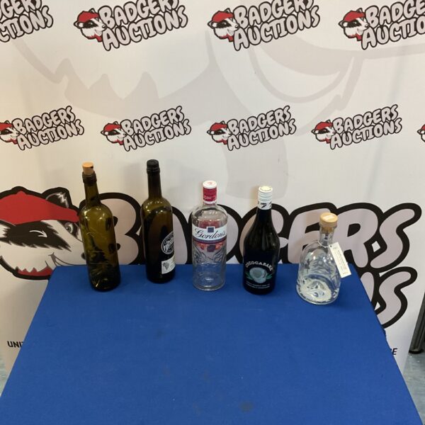 Empty alcohol bottles lot with fairy lights for display.