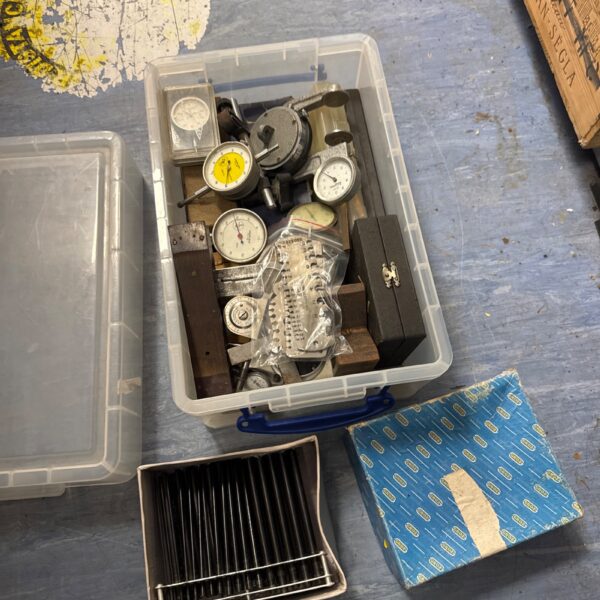Selection of engineering gauges and tools in a storage box.