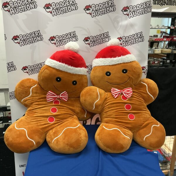 Two large soft ginger men toys, cheerful and collectible.