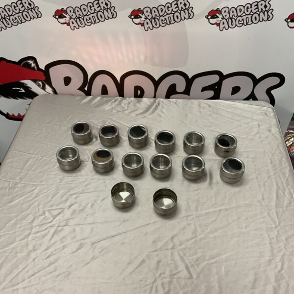 Lot of fourteen stainless steel magnetic spice pots for fridge storage.