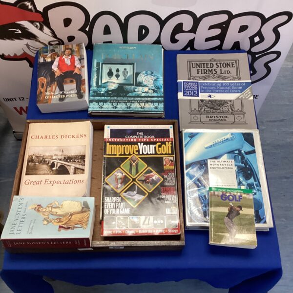 Overview of a mixed book lot including Charles Dickens and golf books.