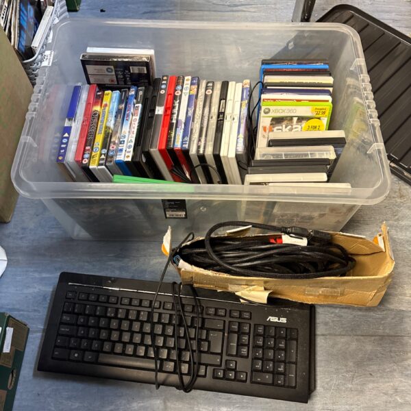 Mixed lot of DVDs, an Asus keyboard, and cables for sale.