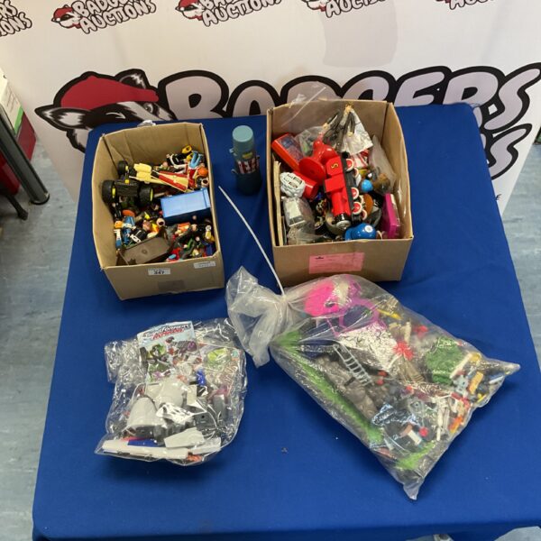 Overview of a mixed toy lot including Playmobil and Transformers.