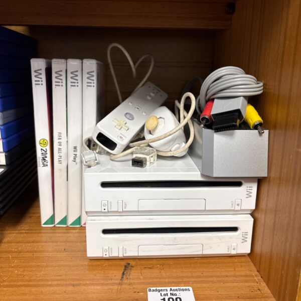 Two Nintendo Wii consoles with games and leads presented in the lot.