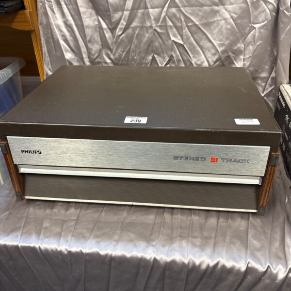 Vintage Philips four-track stereo system with woodgrain finish.