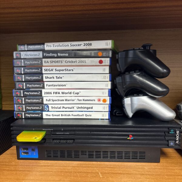 Sony PlayStation 2 console with games and controllers.