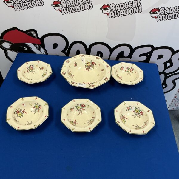 Vintage Royal Doulton bowls with floral pattern on display.