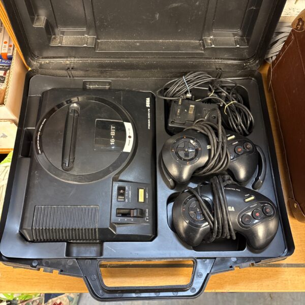 Black Sega Mega Drive 16-bit console with controllers and power supply.