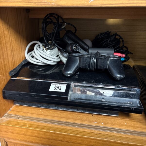 Sony PlayStation 3 console with controller and leads.