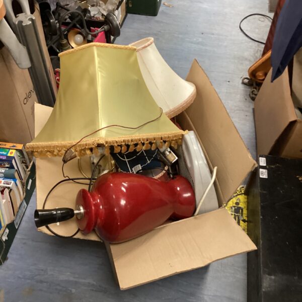 Vintage table lamp with a pale green scalloped shade in a cardboard box.