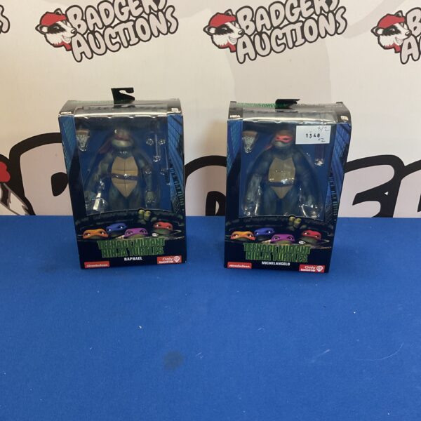 Vintage Teenage Mutant Ninja Turtles Raphael and Michelangelo toys in packaging.