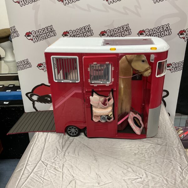 Red toy horse box with horse inside, collectible toy vehicle.