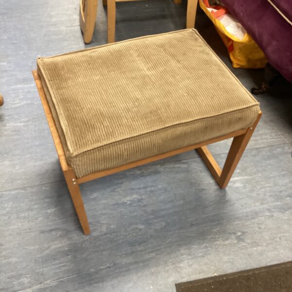 Vintage dressing table stool with textured upholstery and wooden frame.